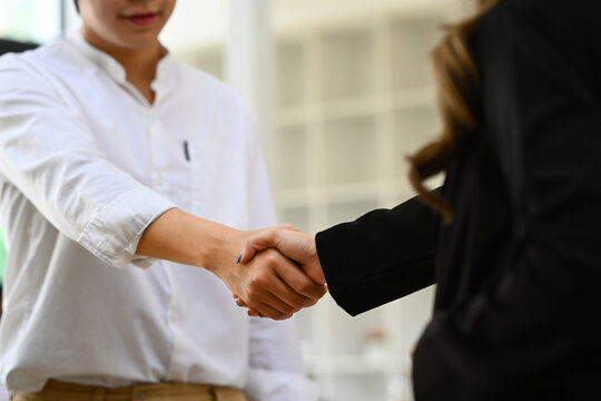 Cropped image of businesspeople shaking hands after successful negotiations at meeting