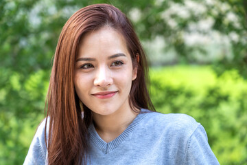Fototapeta premium Portrait of smiling cheerful beautiful pretty asian woman clean fresh healthy white skin posing smile in pajamas grey clothes.Girl felling relax and enjoy time on green at home.asia beauty