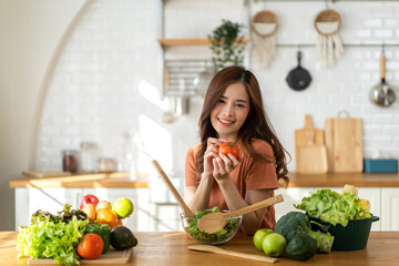 Portrait of beauty body slim healthy asian woman having fun cooking and preparing cooking vegan food healthy eat with fresh vegetable salad on counter in kitchen at home.Diet.Fitness, healthy food