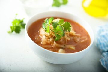 Traditional homemade sauerkraut soup with fresh parsley