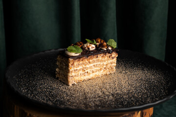 Traditional Hungarian Esterhazy almond chocolate cake decorated with green mint leafs.