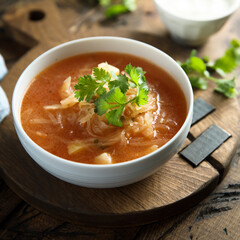 Traditional homemade sauerkraut soup with fresh parsley