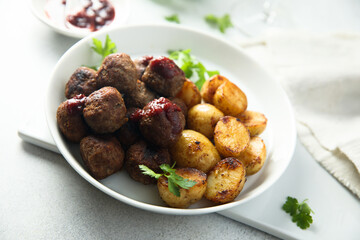 Homemade veal meatballs with potato and berry sauce
