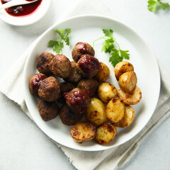 Homemade veal meatballs with potato and berry sauce