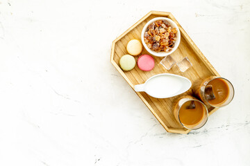 Two glasses of cold iced coffee with macaroons for summer breakfast