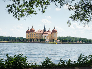 Baroque castle of Moritzburg reflected in a lake and frame