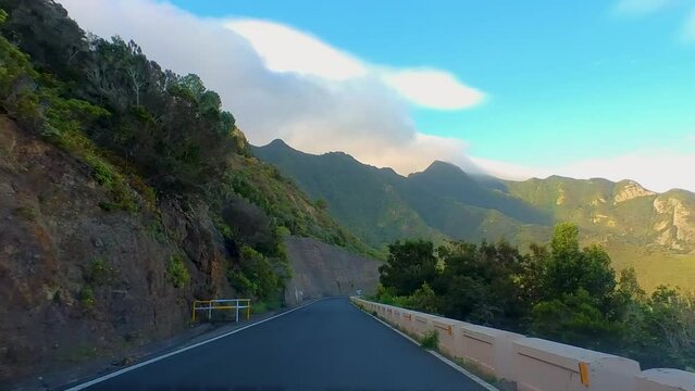 Cinematic Drive On A Curvy Empty Mountain Road, Surrounded By Tall Green Mountains, Clear Blue Sky, Canary Islands, Tenerife, Spain