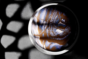 Top view of chocolate mousse cake with space glaze on black background