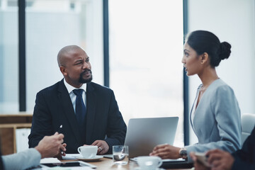 Laptop, teamwork and business people in a meeting for planning a project in office boardroom. Collaboration, discussion and group of professional employees working on corporate research in workplace.