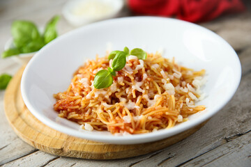 Homemade pasta with tomato and cheese