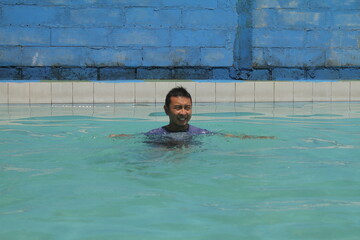 boys and girls practice swimming and playing in water
