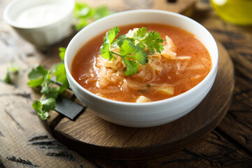 Traditional homemade sauerkraut soup with fresh parsley