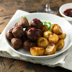 Homemade veal meatballs with potato and berry sauce