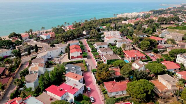 Aerial 4K drone footage of Coma-Ruga, a picturesque city in Spain, during the vibrant springtime.