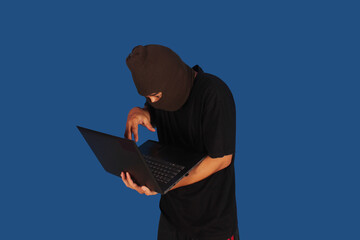 Masked Hacker is Using Computer for Organizing Massive Data Breach Attack on Corporate Servers....