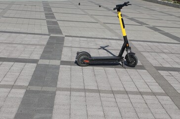Electric scooter outside on a sunny day, with no one around