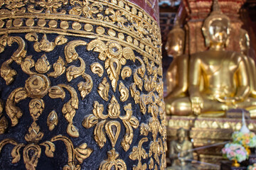 Fototapeta na wymiar Ornamental decoration on a pillar inside a Buddhist temple The Wat Phumin, Nan, Thailand