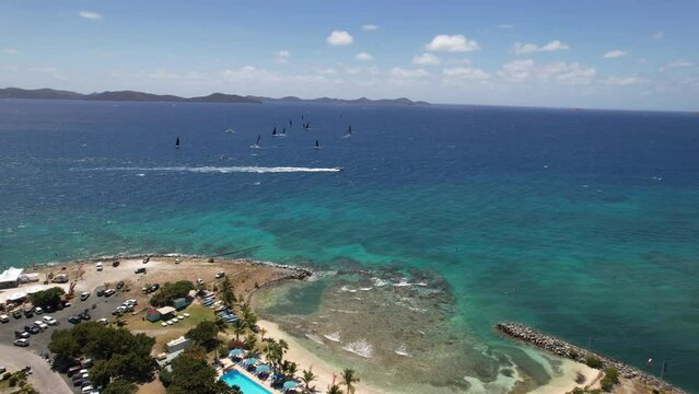 Windsurfers and boats off the island of Tortola drone view