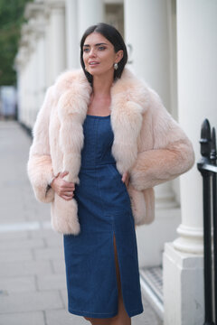 Elegant woman in stylish clothes on London streets.