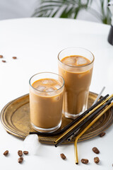 Two iced coffee glasses and straws