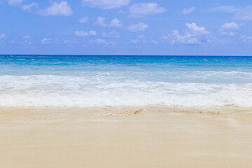 Fototapeta na wymiar Light blue sea waves on clean sandy beach, Tropical white sand beach and soft sunshine background