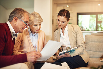 Senior couple, financial advisor and documents for budget, expense or retirement plan on living room sofa at home. Elderly man and woman in finance discussion with consultant, lawyer or paperwork