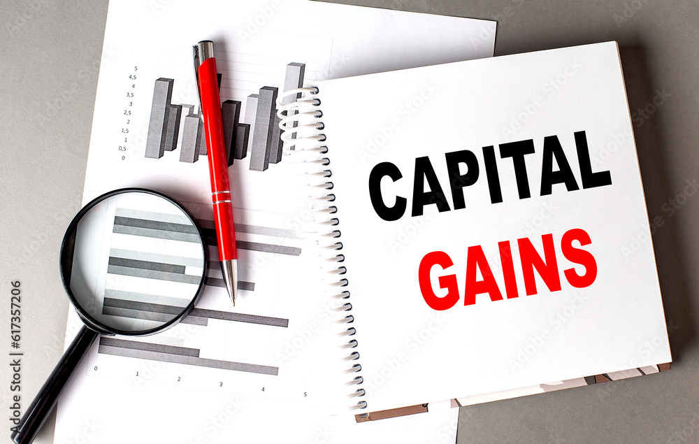 Poster capital gains text written on notebook with chart
