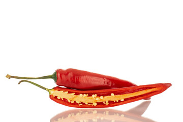 One whole and one half pod of hot red pepper, macro, isolated on white background.
