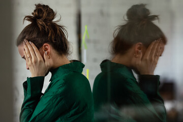 Young sad woman in office, having problem. - obrazy, fototapety, plakaty