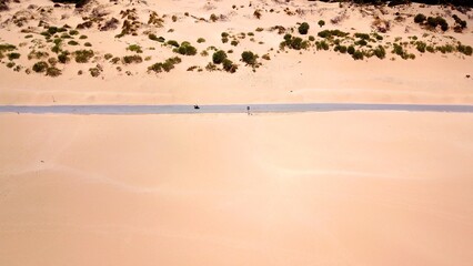aerial view of a motor roller driving on a road in a sandy dune landscape near Valdevaqueros with a pine forest in the background, Tarifa, Cadiz, Andalusia, Spain, fantastic landscape, tourism, travel