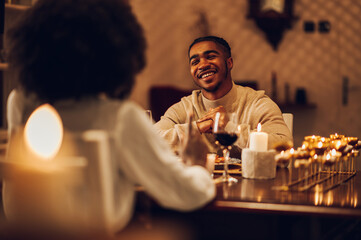 Smiling african american man having a romantic date with his girlfriend at home