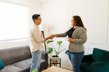 Woman psychologist shaking hands with a male patient