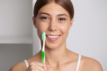 Happy Lady Brushing Teeth With Toothbrush Standing In Bathroom