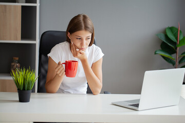 Unhappy young worker suffering from aching teeth in the office