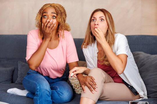 Girl Friends Watching Scary Movie On TV At Home