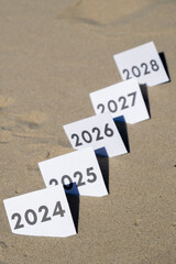 Paper cards with numbers of years from 2024 to 2028 in a row. New year start concept. Resolution...