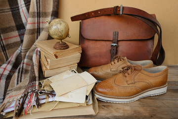 old nostalgic sentimental things, family vintage photographs, stack of books, shoes, leather...