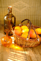 ripe apples in basket, bottle of cider, apple juice, rustic table flooded with warm sunlight, concept harvest, abundance, natural beauty, farm-to-table, refreshment and relaxation