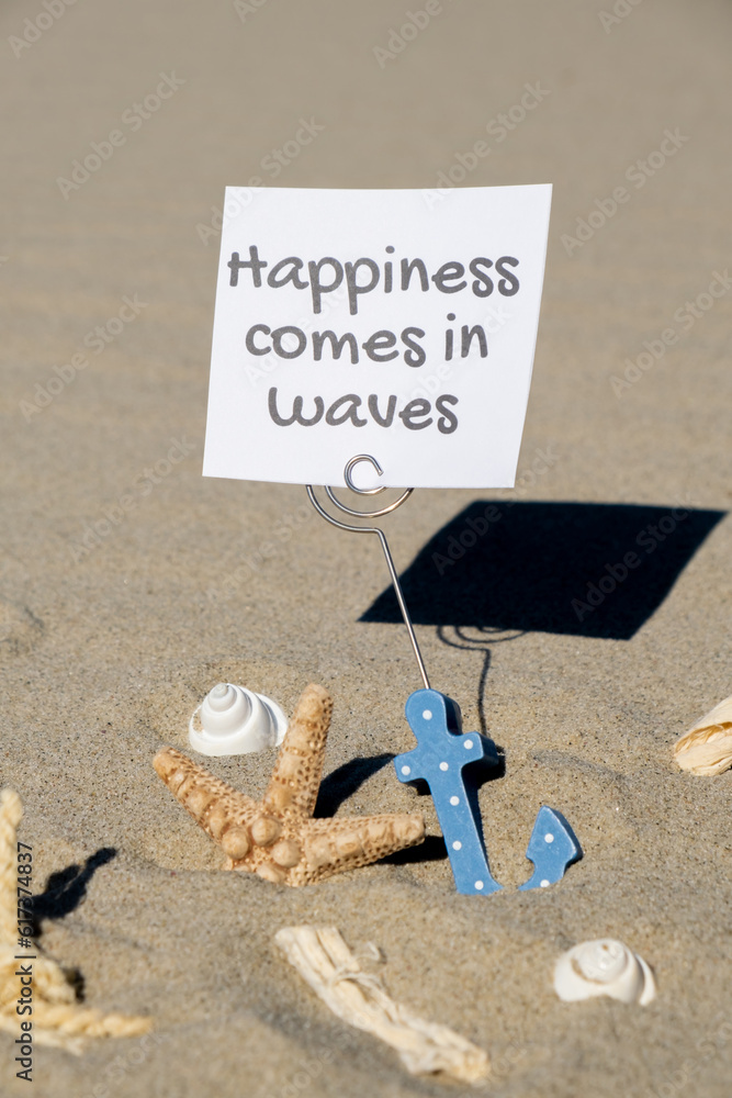 Wall mural happiness comes in waves text on paper greeting card in anchor paper holder and starfish seashell su