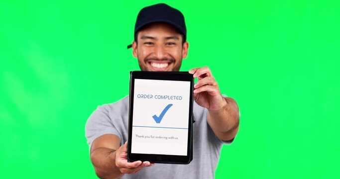 Asian man, tablet and green screen for payment success or transaction against a studio background. Portrait of male person or delivery guy show technology app, display and ecommerce order or purchase