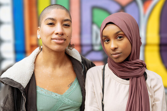 Portrait of young women at mural wall