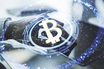 Double exposure of creative Bitcoin symbol with finger clicks on a digital tablet on background....
