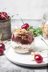 Granola with yogurt and cherries in a glass