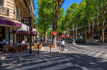 Cozy street with tables of cafe  in Paris, France. Cityscape of Paris. Architecture and landmarks...