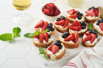 American flag sandwich with strawberries, blueberries, whipped sweet cream, soft cheese on toast bread. 4th of July American Independence Day food. Independence or Patriotic Day breakfast idea Mock up