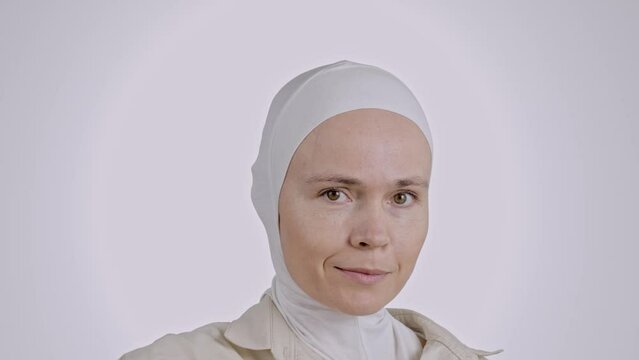 Cute muslim female shows a kraft paper bag with heart window