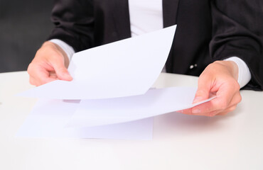 Businesswoman analyzes / reads documents before a deal