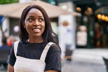 Young african american woman smiling confident standing at street