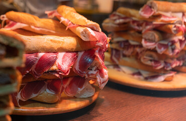 Spanish street food, Spanish sandwiches with sliced iberian cured ham jamon, bocadillo