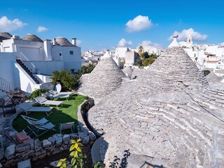 Grey stone cone roofs of historical houses in Alberobello, Italy